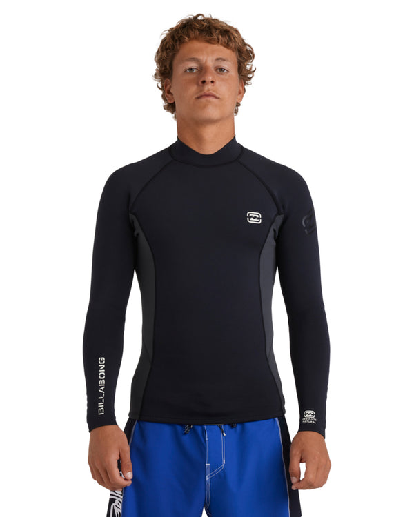 Man wearing black long sleeve wetsuit top with small chest and sleeve logo, front view.