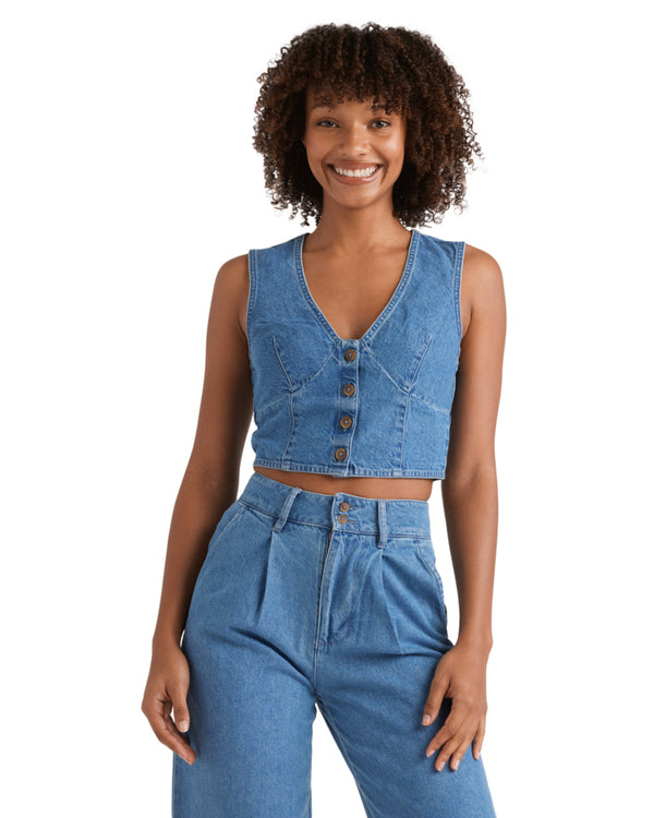 Denim crop vest with button-up front and deep V-neckline, styled with matching high-waisted jeans.
