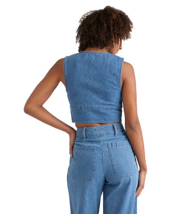 Back view of a sleeveless denim vest paired with wide-leg high-rise denim pants.