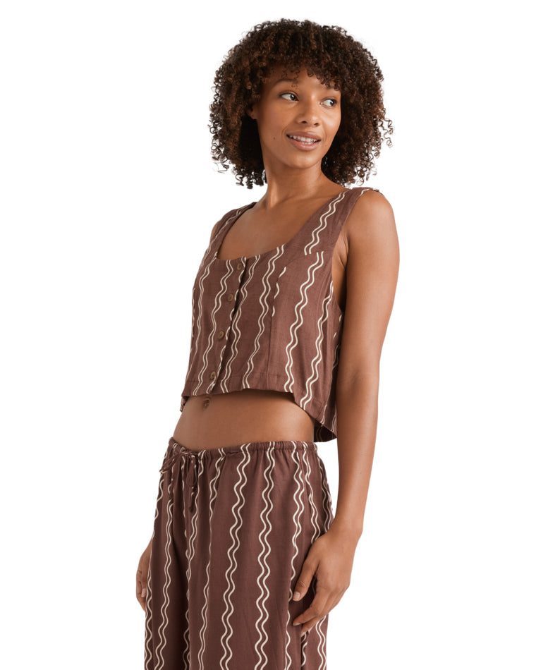 Side view of brown sleeveless crop top with scoop neckline and zig-zag stripe print.