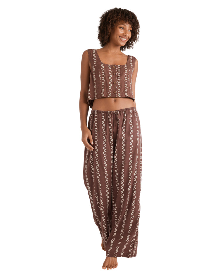 Brown wide-leg pants with matching zig-zag stripe print and relaxed drawstring waist.