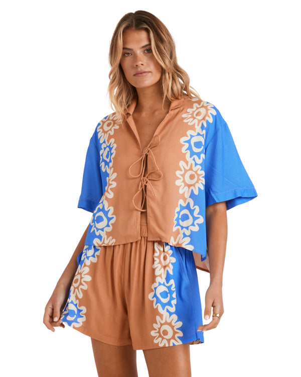 Brown and blue short-sleeve shirt with a floral print and front tie detail.