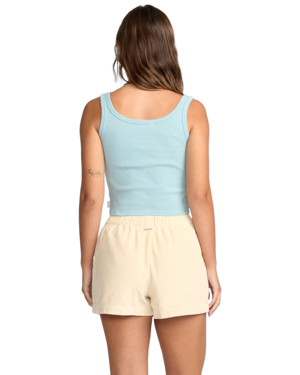 Back view of light blue tank top and cream corduroy shorts with elastic waistband