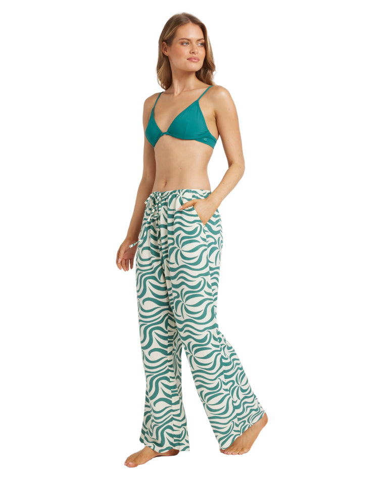 Side view of relaxed fit wide leg pants with green and white swirl pattern.