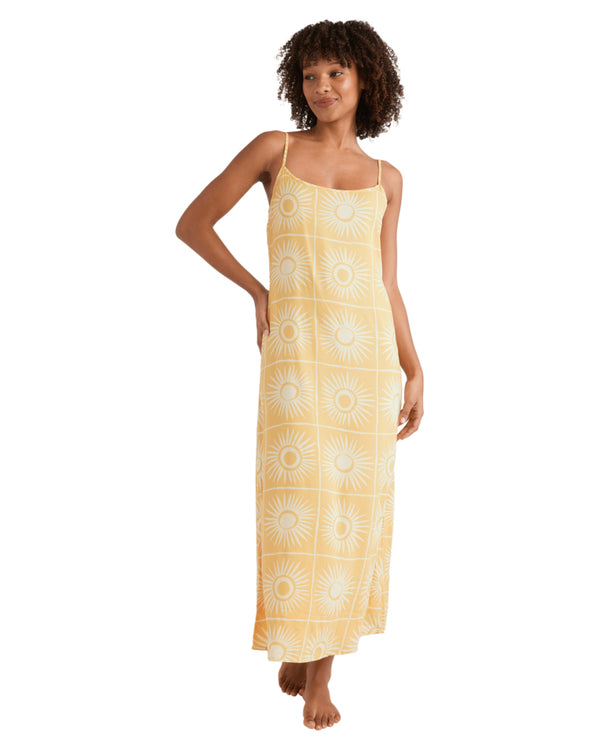 Yellow maxi dress with spaghetti straps and sunburst print, fitted at the top with relaxed skirt