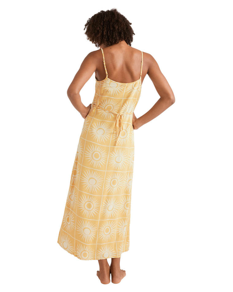 Back view of yellow sunburst maxi dress with tie waist and adjustable straps