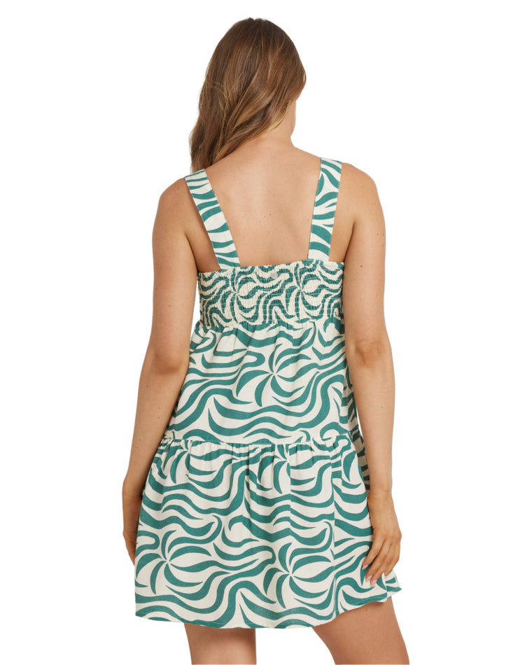 Back view of wave print mini dress with shirred panel and wide shoulder straps.