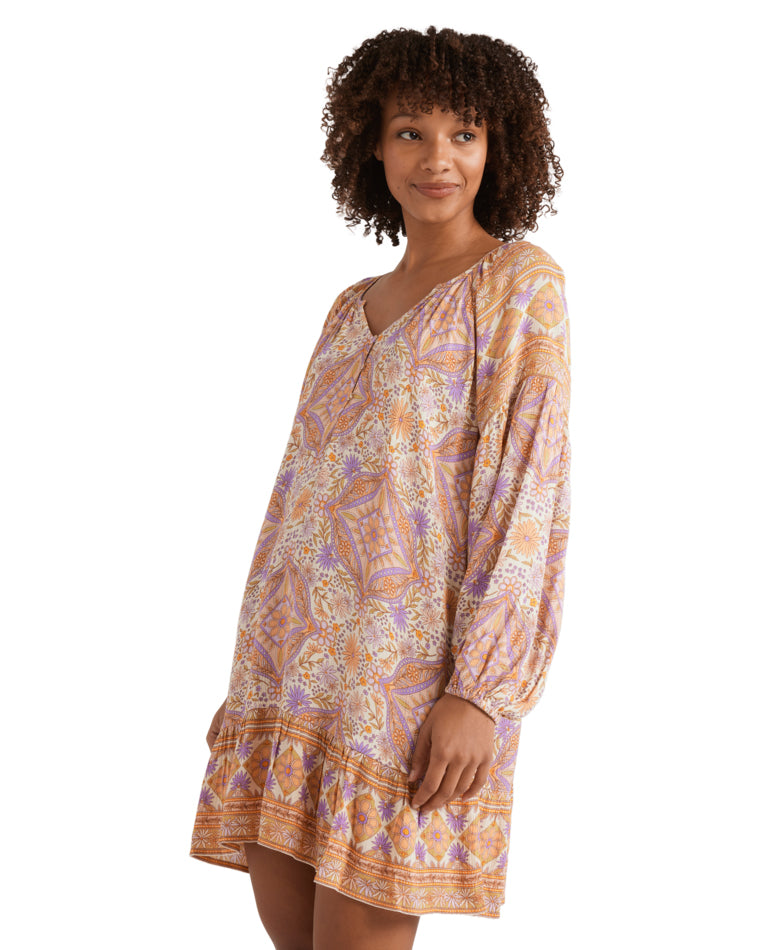 Side view of the boho-style printed mini dress with loose fit and V-neckline.