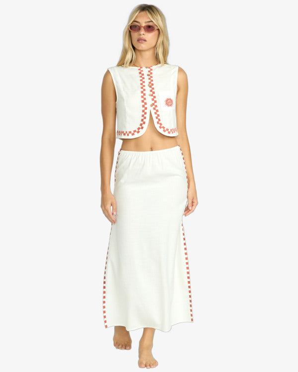 Cream two-piece set with red trim featuring sleeveless crop top and matching maxi skirt.