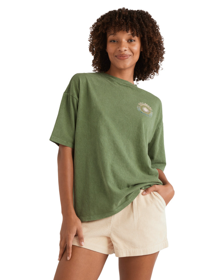 Green oversized tee with small front sun and wave graphic on chest.