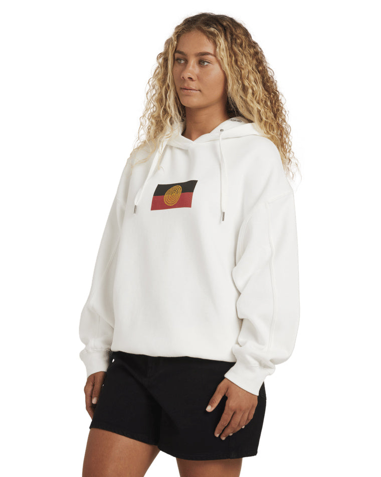 Side angle of model wearing white hoodie with Aboriginal flag.