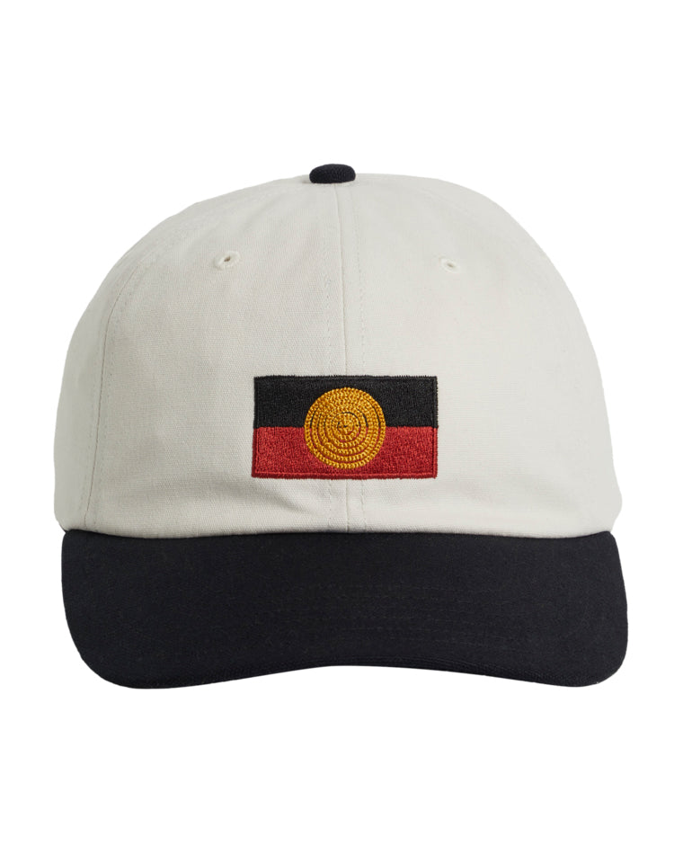 White cap with black brim featuring an embroidered Aboriginal flag on the front.