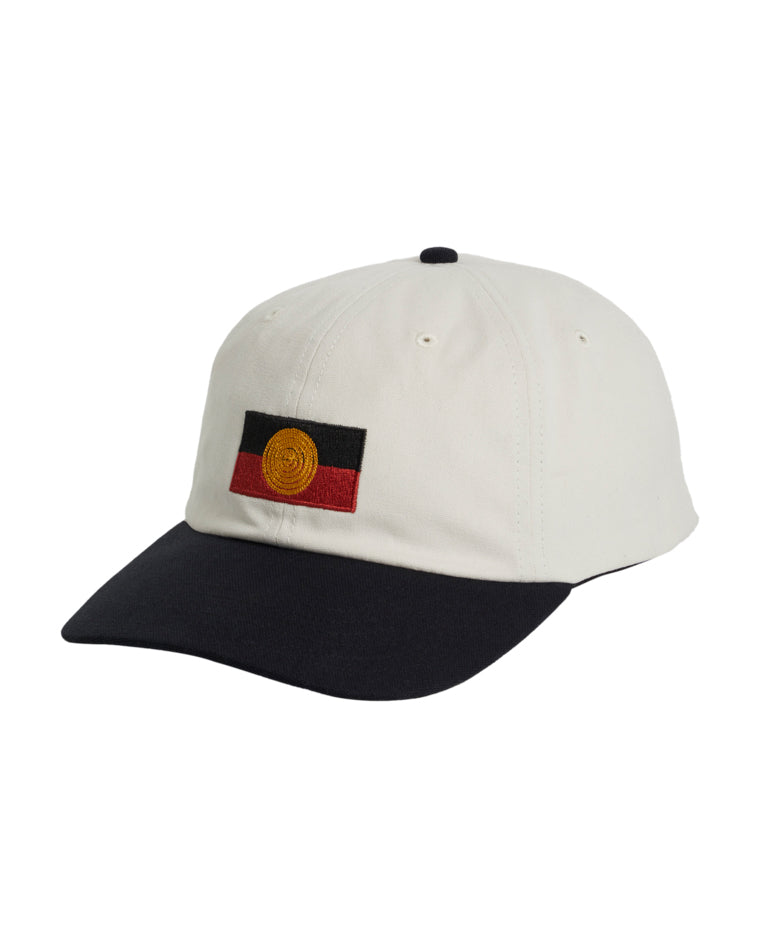 Angled side view of white cap with black brim and Aboriginal flag embroidery on the front.