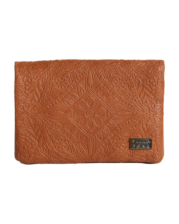 Embossed tan wallet with intricate floral and diamond pattern and a small Billabong logo plate.
