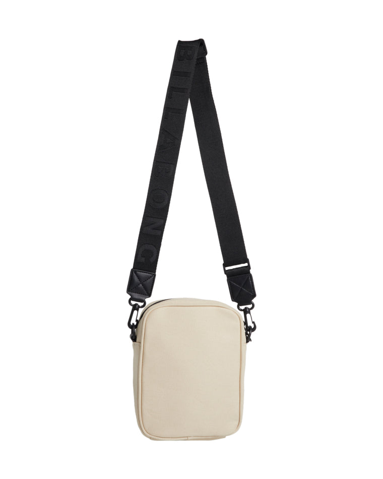 Back view of beige Billabong crossbody bag with plain design and black adjustable logo strap.