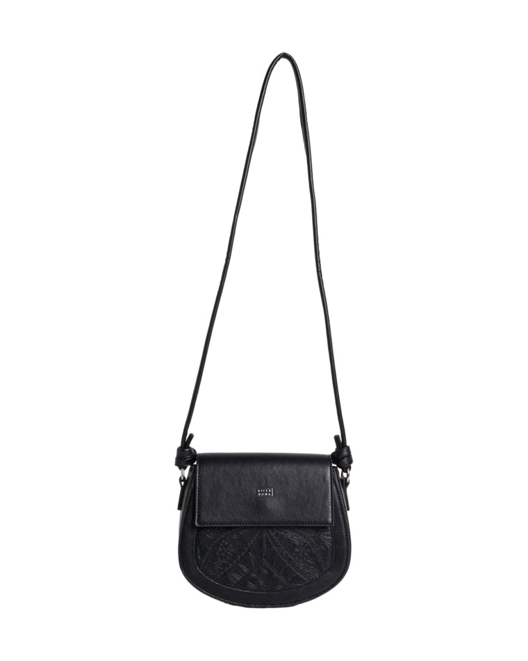 Black crossbody bag with embossed front pocket, flap closure, and long adjustable strap.