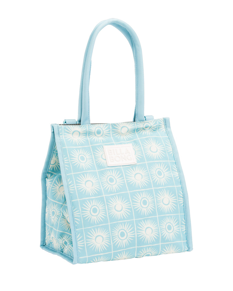 Angled view of light blue Billabong tote featuring white sunburst print and front logo patch.