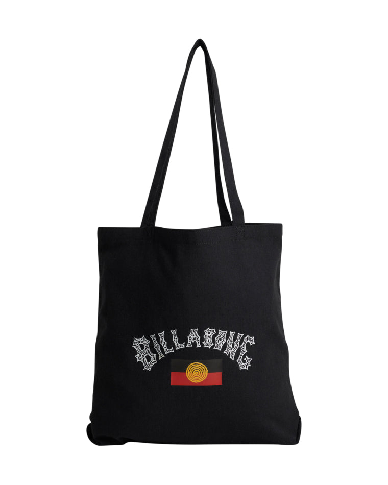 Black tote bag with white Billabong logo in spiderweb font above a yellow and red circular graphic