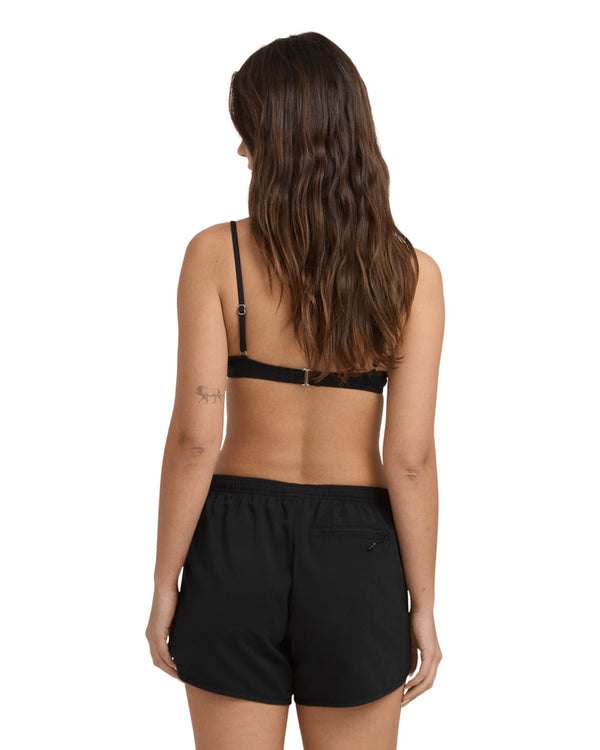 Back view of black bikini top and black shorts with elastic waistband and small zip pocket.