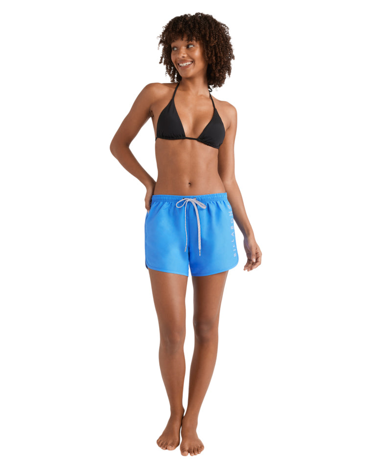 Full body view of black bikini top and bright blue boardshorts with relaxed fit and drawcord waist