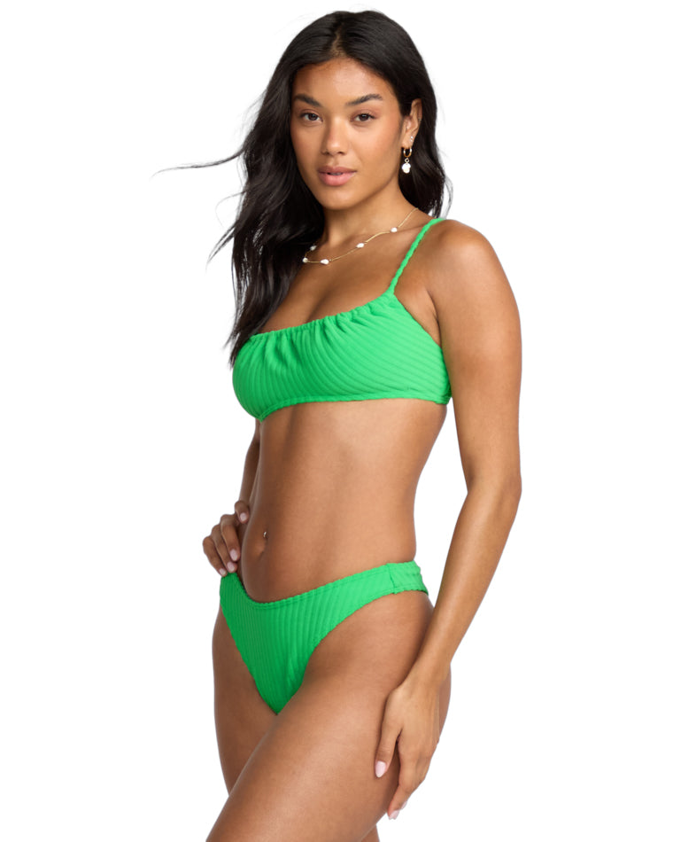 Side view of green scoop neck bikini with ribbed fabric and high-leg bottom