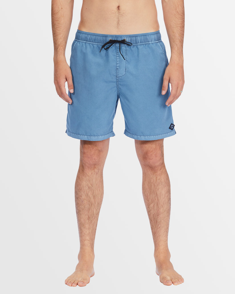 Front view of men’s mid-length blue boardshorts with drawstring waist.