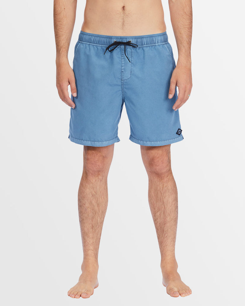 Front view of men’s mid-length blue boardshorts with drawstring waist.