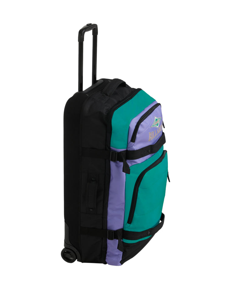Side view of Billabong travel bag showing dual compartments, compression straps and inline skate wheels