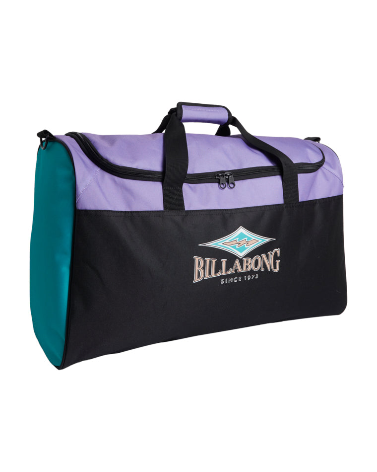 Angled side view of Billabong duffle bag with visible teal side and black logo front.
