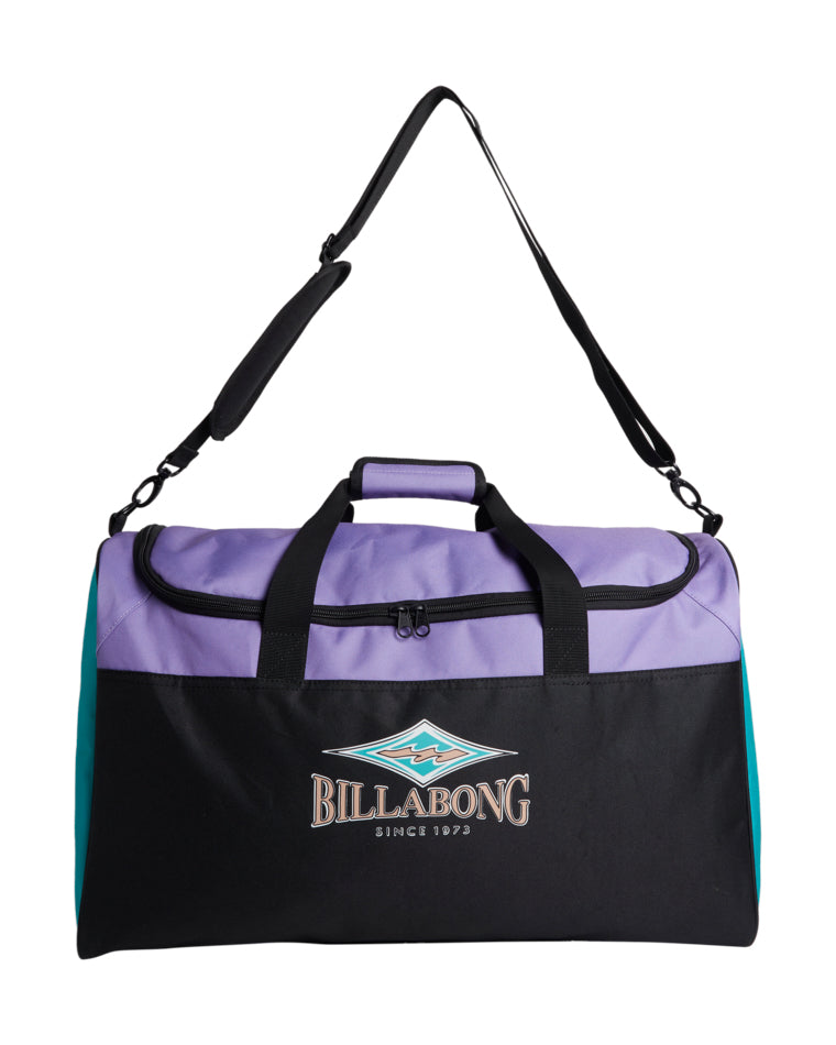 Front view of a Billabong duffle bag in purple, black, and teal with shoulder strap and front logo.
