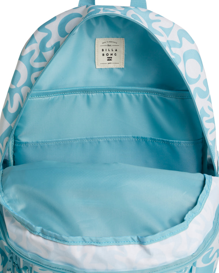 Interior view of a backpack showing a light blue lining and inner sleeve with a stitched Billabong brand label.