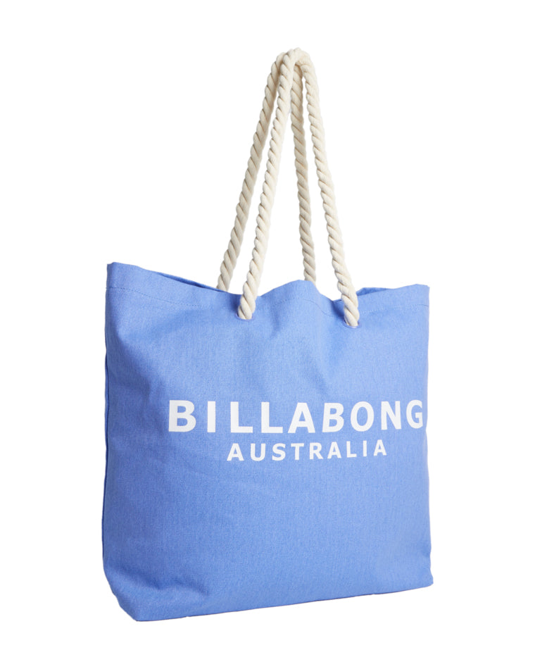 Angled front-side view of a light blue Billabong Australia tote bag with white rope handles and bold white branding on the front.
