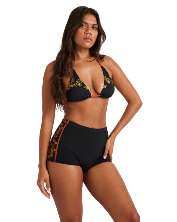 High-waisted black surf shorts with red and gold floral side detailing.