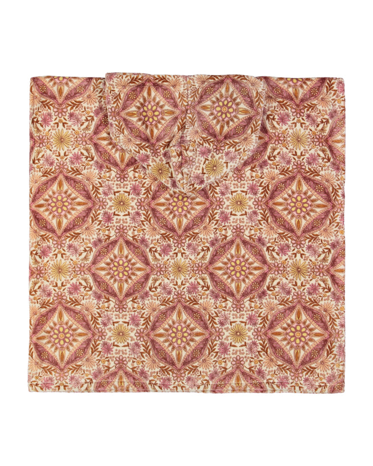 Back view of the hooded changing towel, laid flat to show the full symmetrical floral pattern and hood design.