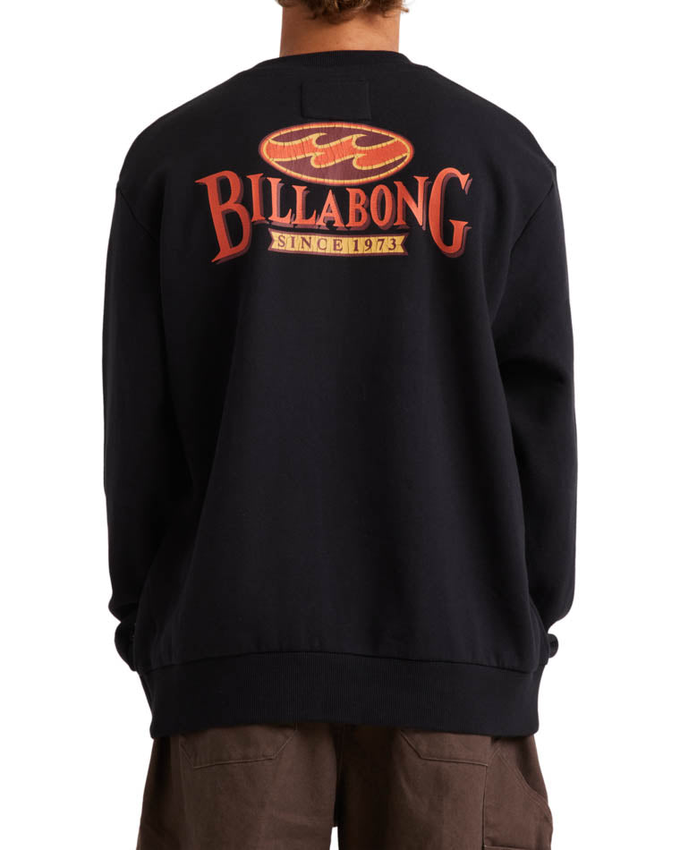 Back view of a black Billabong crewneck sweatshirt featuring a large red and yellow 'Billabong Since 1973' graphic design