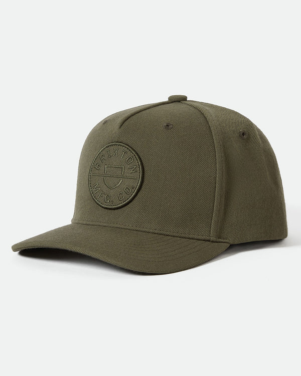 Olive green snapback cap with an embroidered circular logo on the front, featuring a curved brim and five-panel construction.