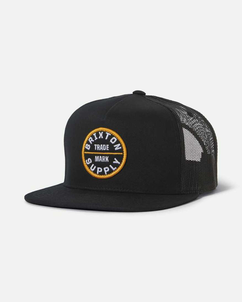 Black Brixton trucker cap with mesh back and circular Brixton Supply patch on front.