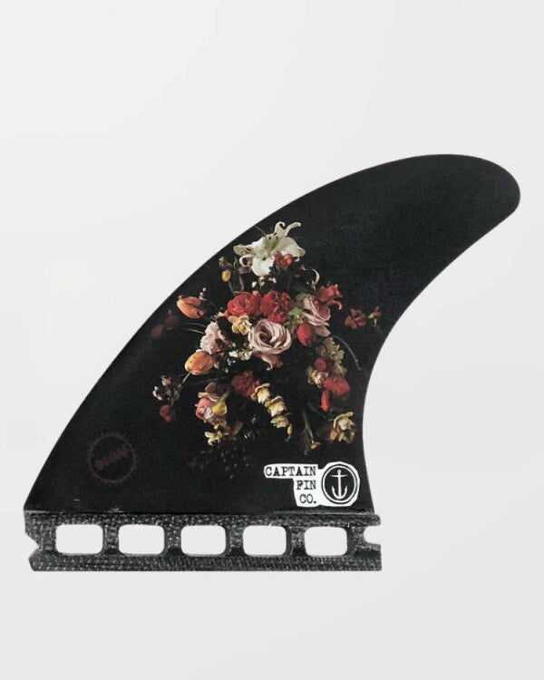 Black Captain Fin Co surfboard fin with floral bouquet print and dual tab base.