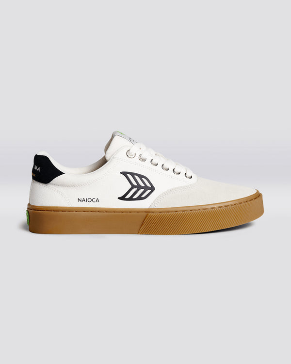 White Cariuma Naioca skate shoe with black logo detail, black heel tab, and gum sole, featuring a minimalist design.