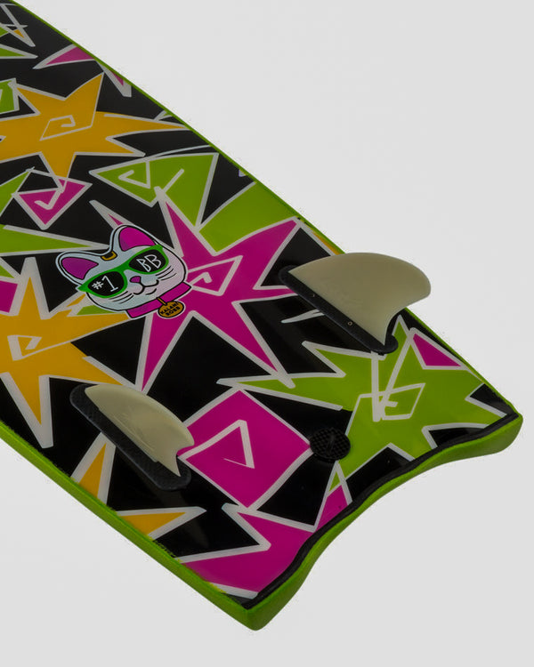 Close-up of Catch Surf Beater 54 twin fin setup with colourful neon base and cartoon cat graphic above fins.