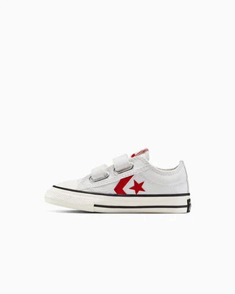 White Converse sneakers with red star logo and double velcro straps, inner side.