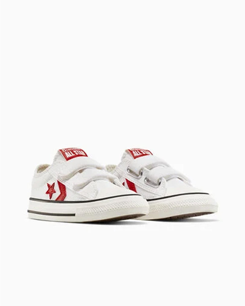 White Converse sneakers with red logo and velcro straps, angled pair view.