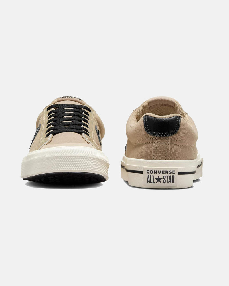 Front and back view of beige Converse low-top sneakers, featuring black laces, star logo, and 'Converse All-Star' branding.