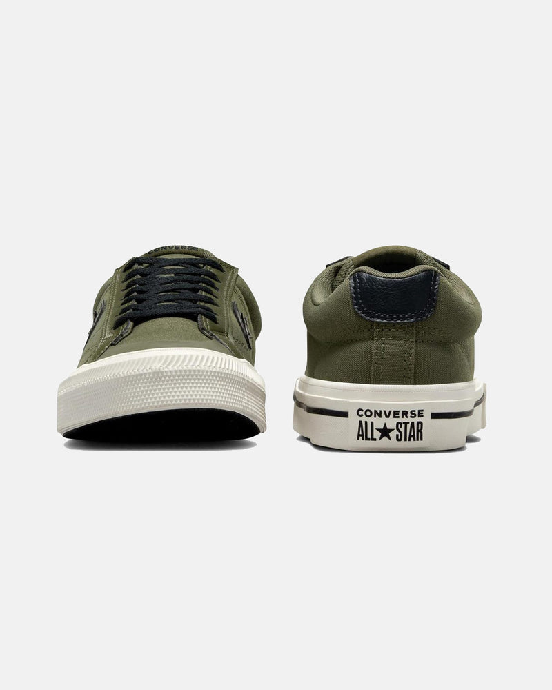 Front and back view of olive green low-top sneakers featuring black laces, a Converse All Star logo, and white rubber soles.