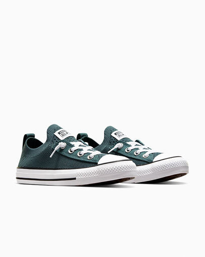 Angled view of green knit Converse sneakers with white laces and toe caps, shown as a pair.