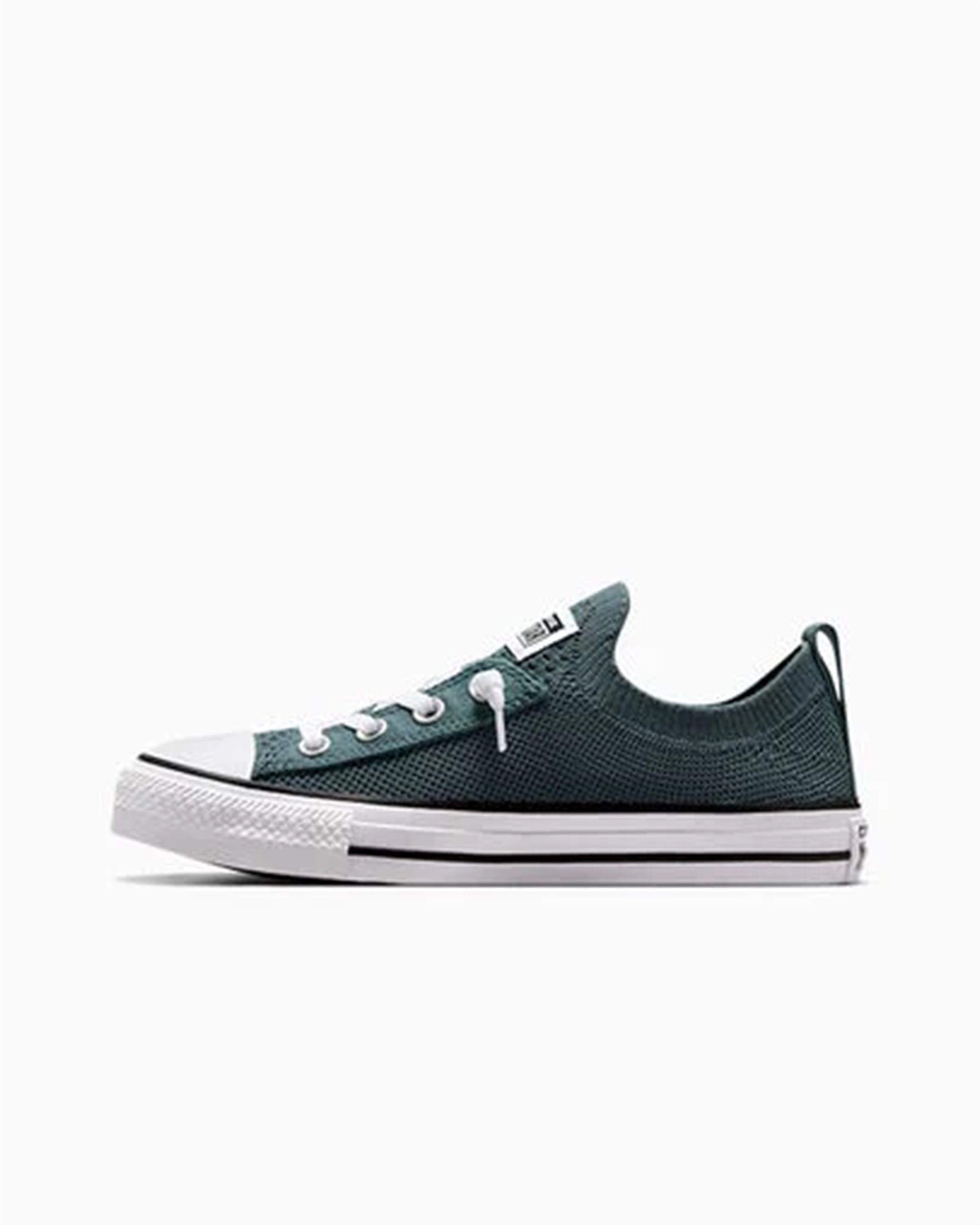 Inner side view of green knit Converse low-top with pull tab and classic white rubber sole.