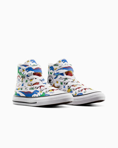 Pair of Converse high-tops with multicolour dinosaur print, front three-quarter angle showing velcro and laces.
