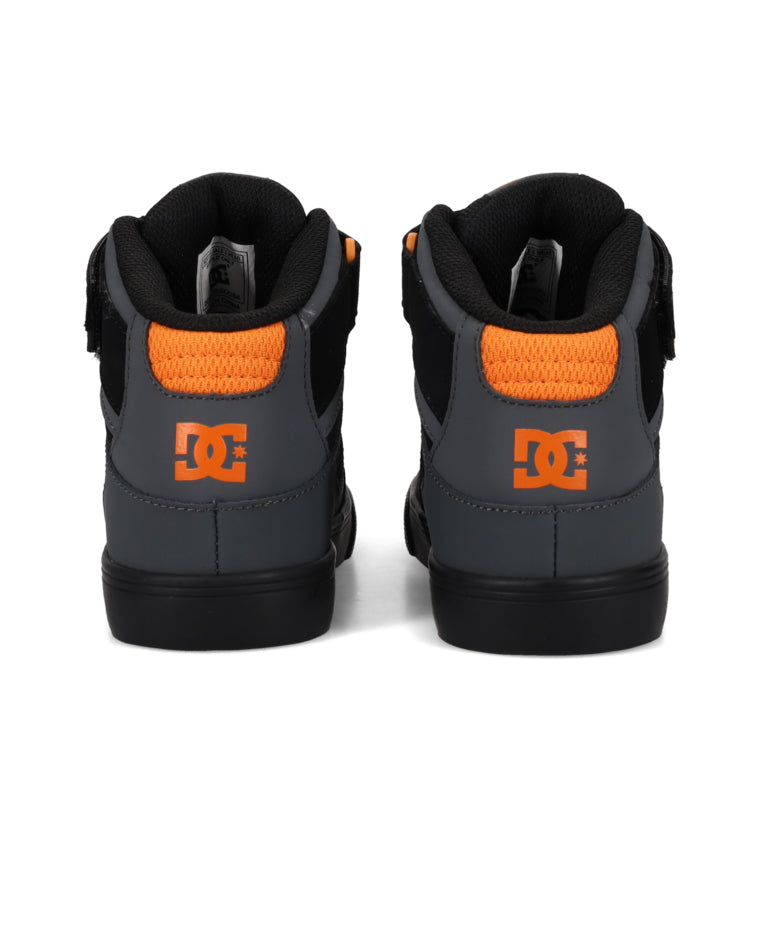 Rear view of DC skate shoes showing orange DC logo on grey heel panel