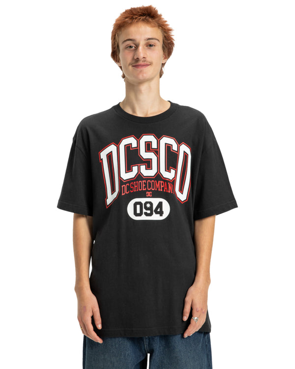 Black DC Shoes tee with bold red and white DCSCO logo and 094 graphic on the front.