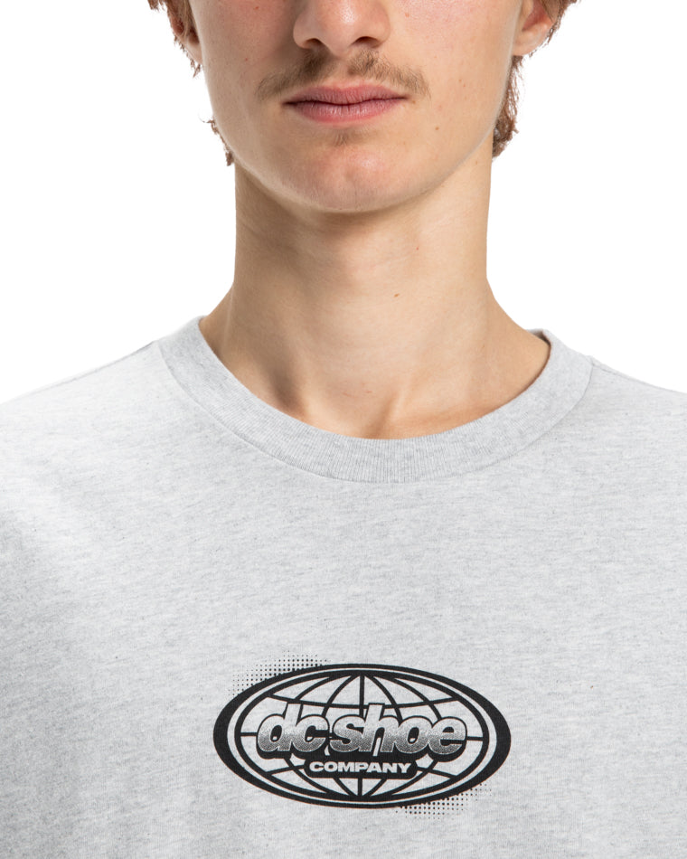 Close-up of black and white globe logo on grey DC Shoes t-shirt.